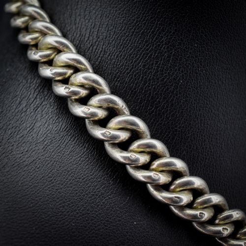 fig 2. An antique sterling silver Albert watch chain featuring heavy curb links, double swivel clasps, and a central T-bar attachment.