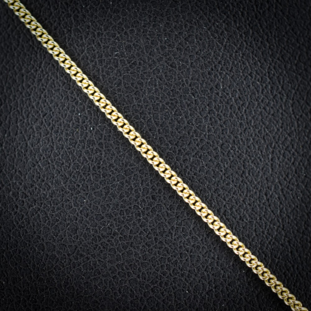 An antique yellow gold necklace featuring a flower cluster pendant set with old cut diamonds suspended on a fine chain. View II