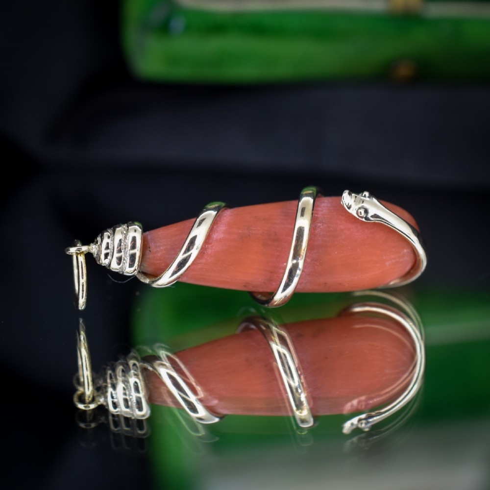 An antique Victorian pendant featuring an orange coral drop wrapped with a coiled 15ct gold snake motif. View II