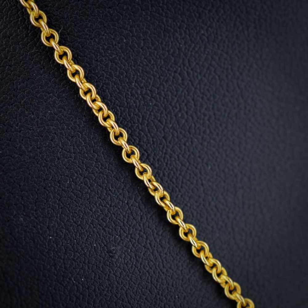 A 15ct yellow gold chain supporting a circular drop pendant featuring an Australian continent map cutout set between two round paste stones. View II