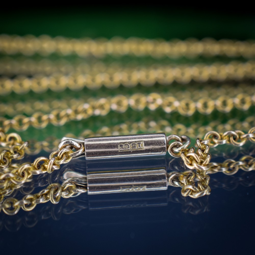A 15ct yellow gold chain supporting a circular drop pendant featuring an Australian continent map cutout set between two round paste stones. View VI