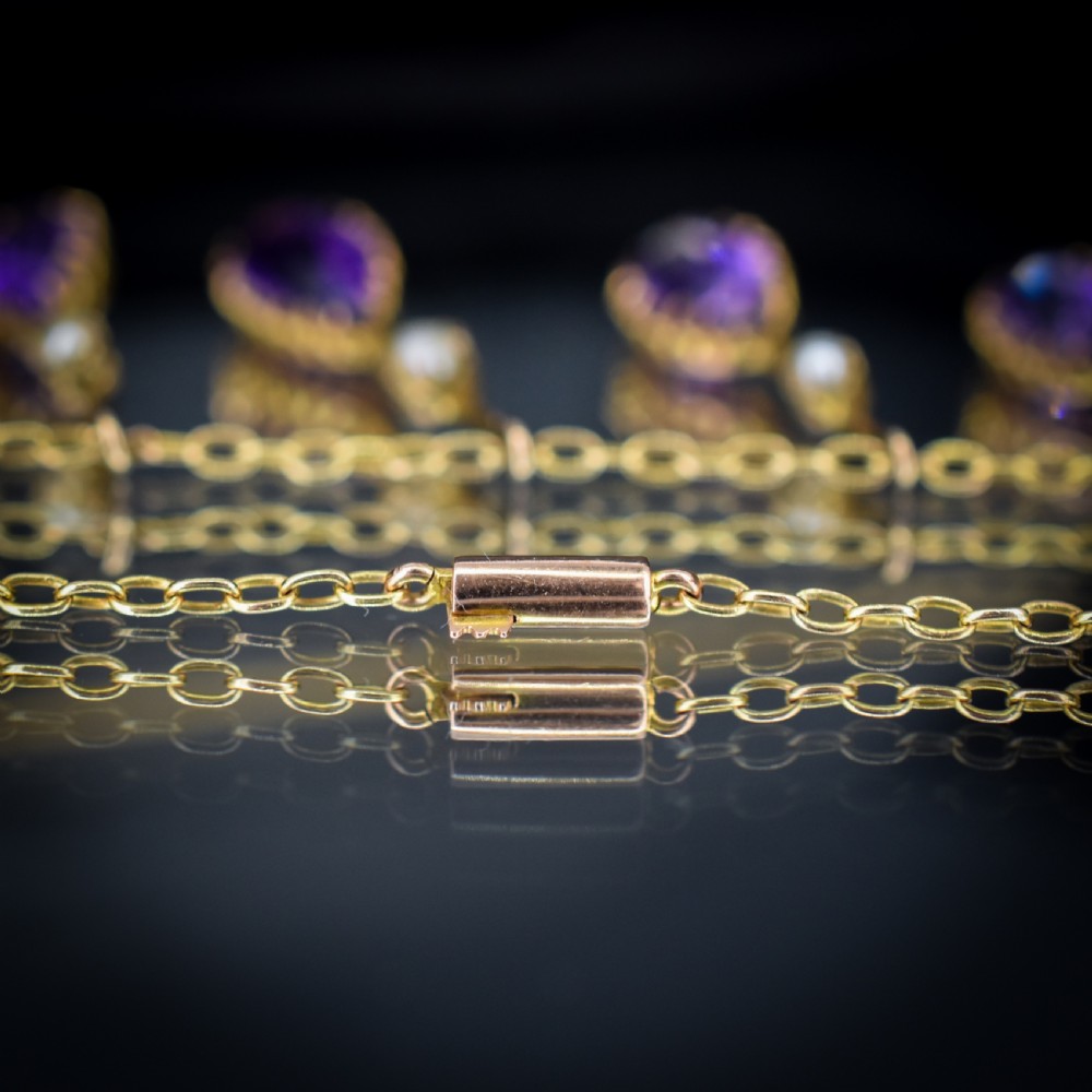 An antique gold fringe necklace featuring suspended pear-cut amethyst drops and seed pearls. View IX