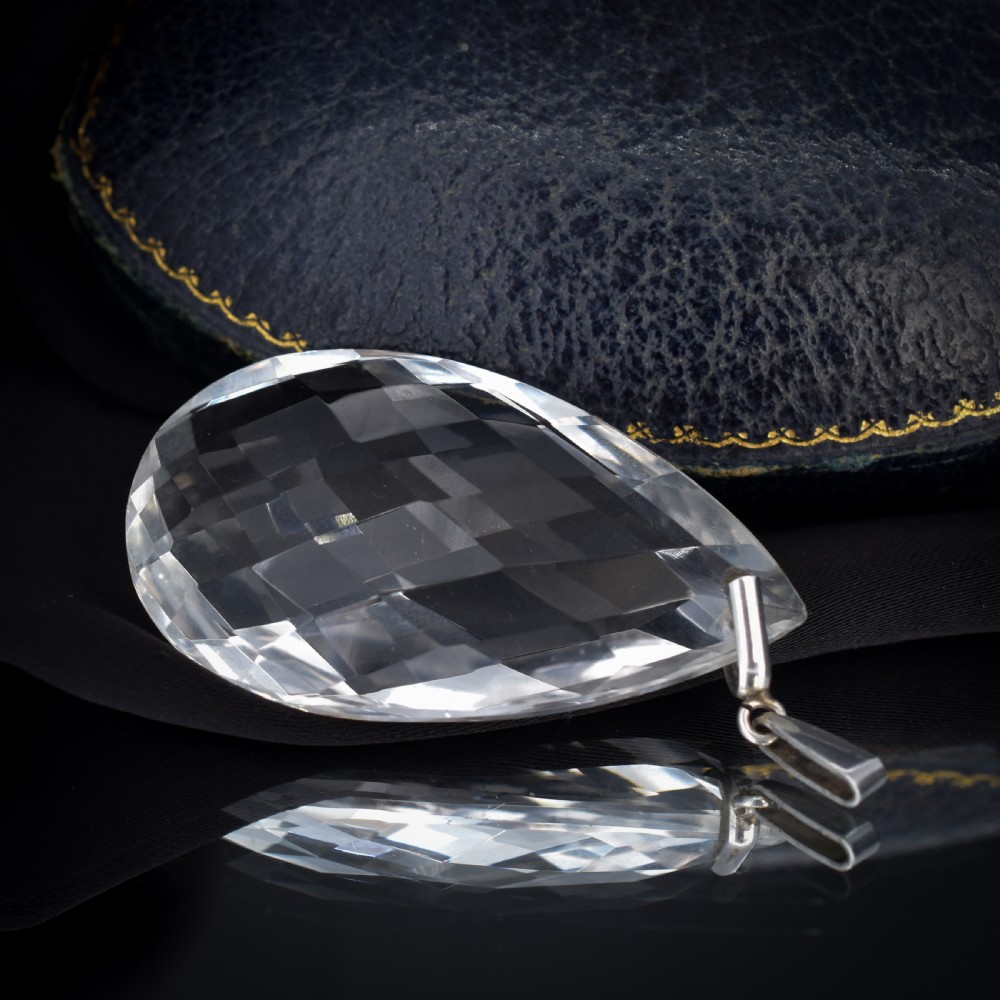 A large faceted pear-shaped clear rock crystal drop pendant featuring a sterling silver mounting loop. View V