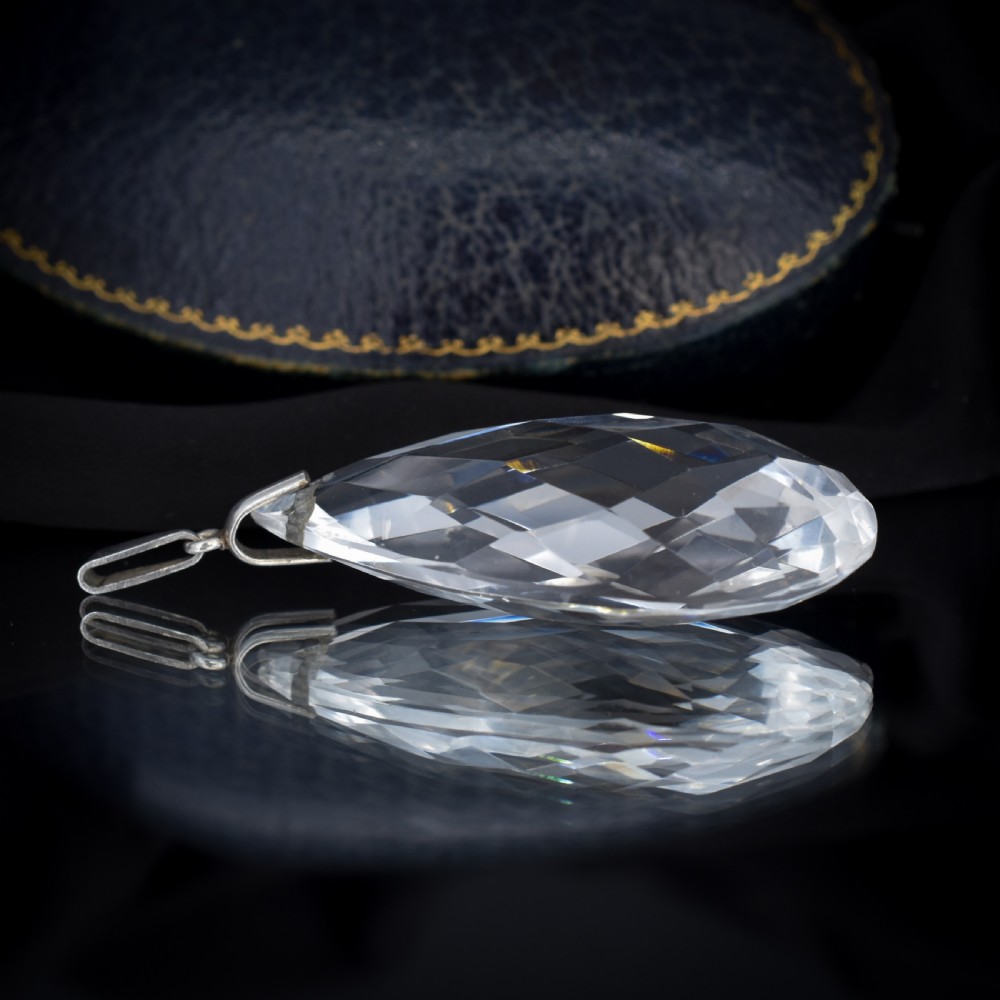 A large faceted pear-shaped clear rock crystal drop pendant featuring a sterling silver mounting loop. View VI