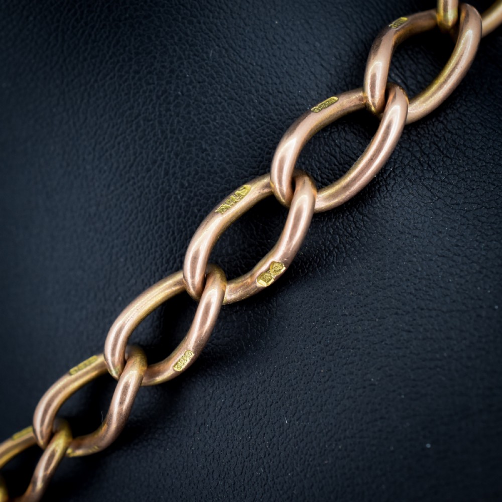An antique 9ct gold Albert watch chain featuring oval links, a central T-bar, and double dog clip clasps. View II