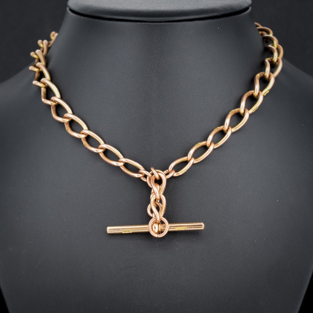 An antique 9ct gold Albert watch chain featuring oval links, a central T-bar, and double dog clip clasps. View IV