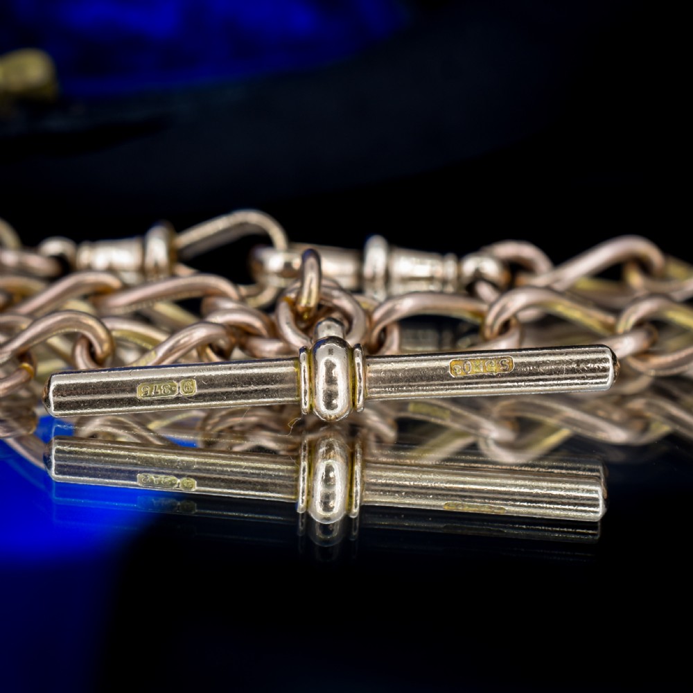 An antique 9ct gold Albert watch chain featuring oval links, a central T-bar, and double dog clip clasps. View V