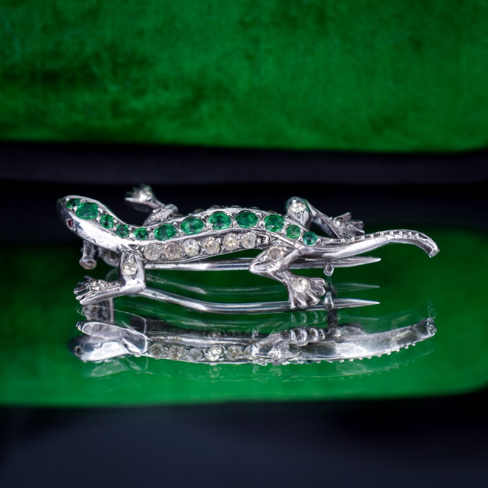 A Victorian silver lizard brooch set with green and clear paste stones. View II
