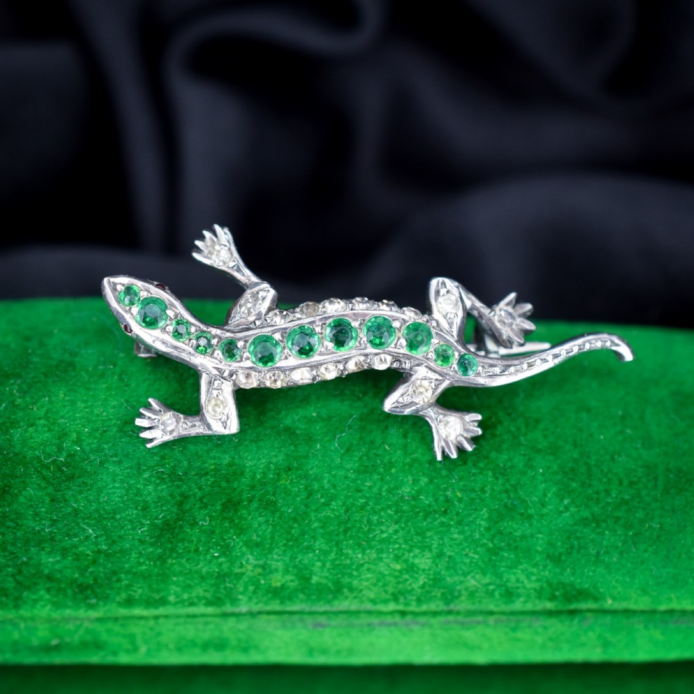 A Victorian silver lizard brooch set with green and clear paste stones. View III