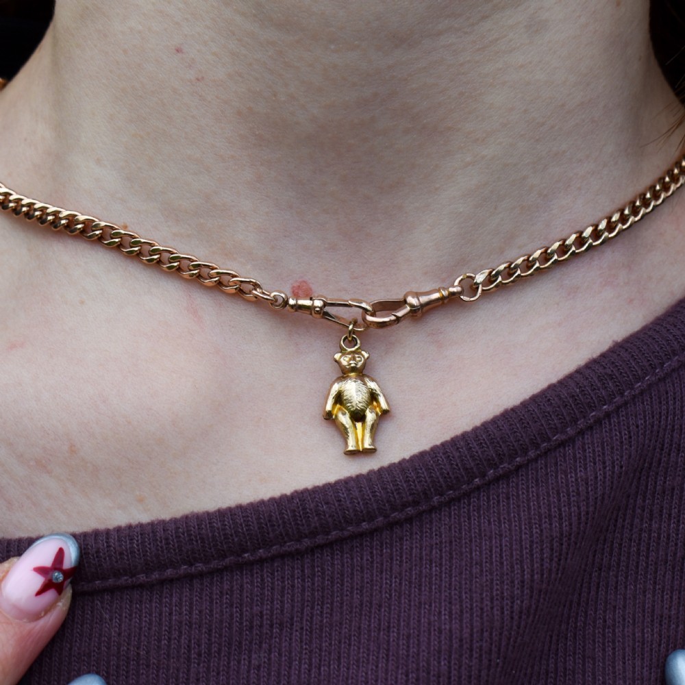 An antique 9ct gold teddy bear charm featuring a textured fur surface and a gold suspension loop. View II