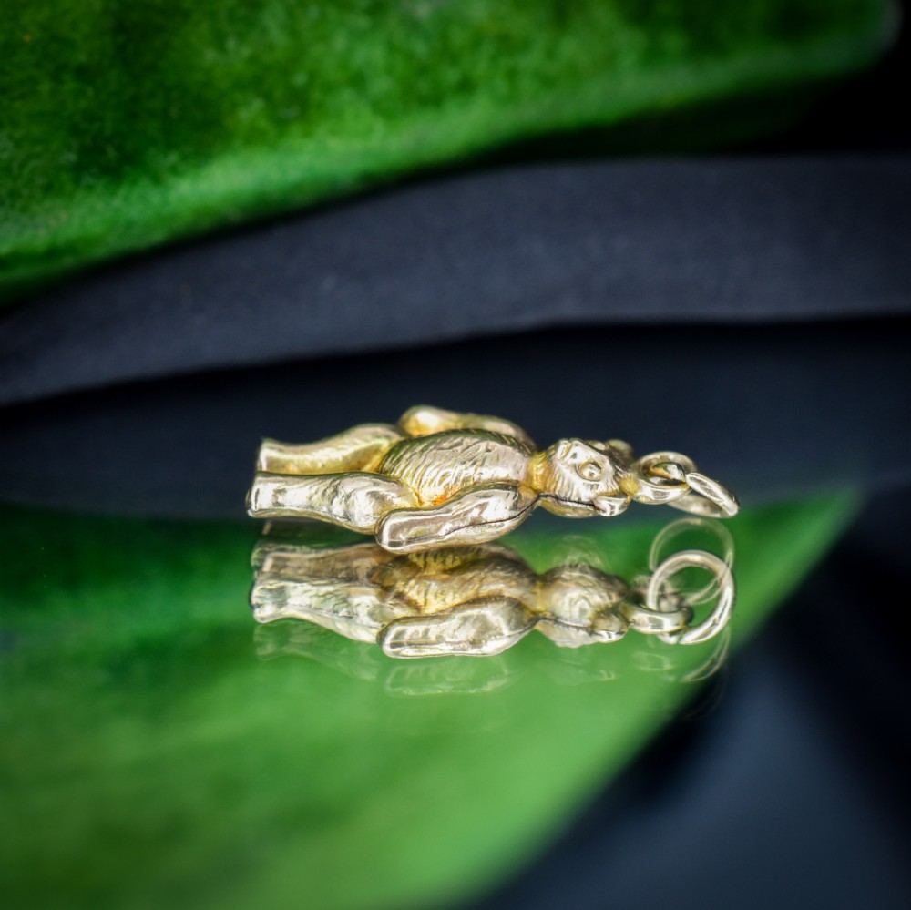 An antique 9ct gold teddy bear charm featuring a textured fur surface and a gold suspension loop. View VI