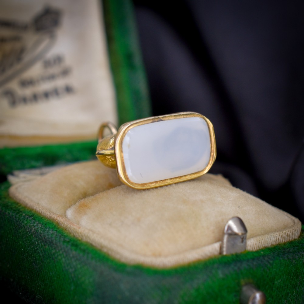 An antique gold-cased fob seal featuring a sculpted elephant figure mounted on a patterned base with a flat chalcedony matrix. View VII