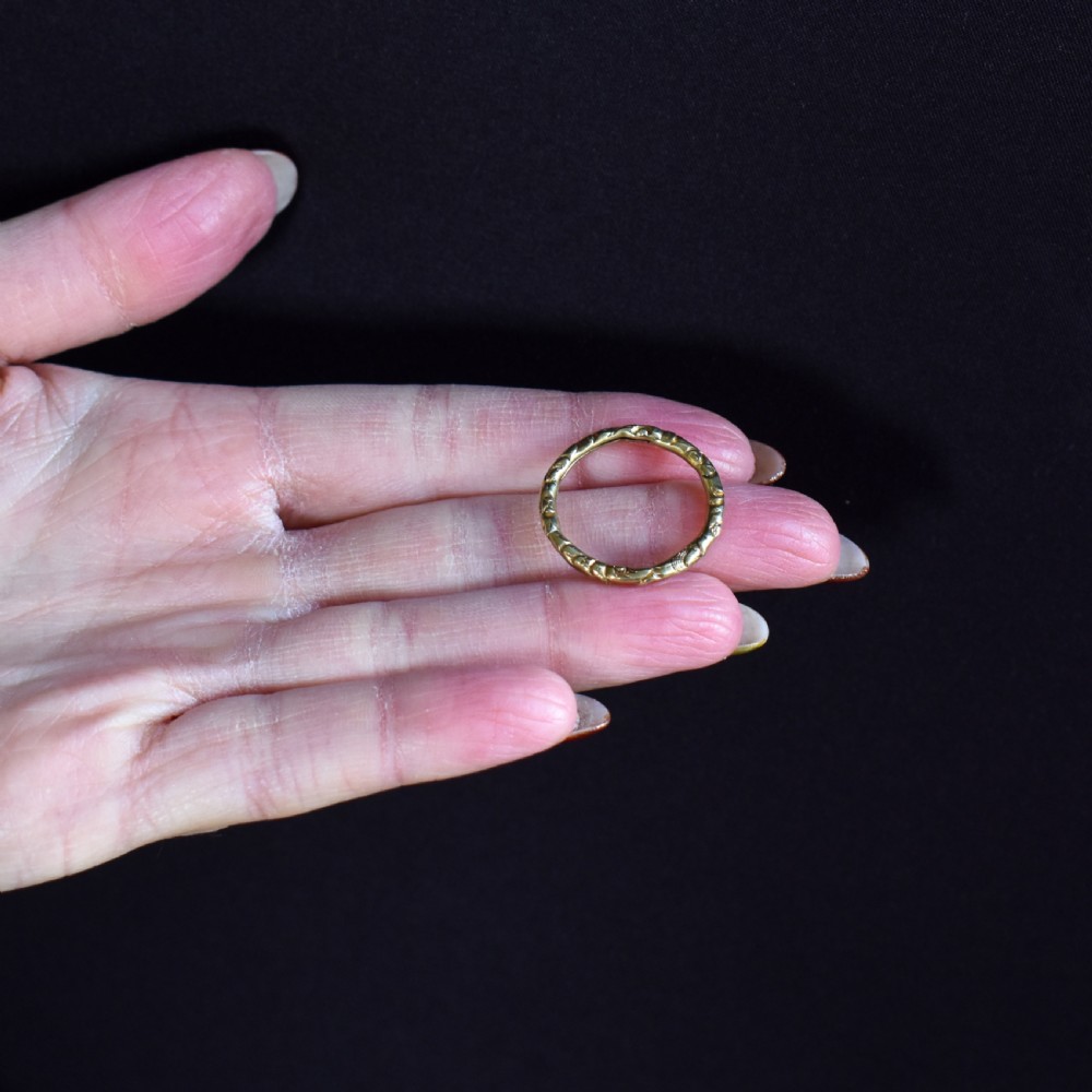 A circular Georgian 12ct yellow gold split ring featuring hand-engraved scrollwork around the outer edge. View V