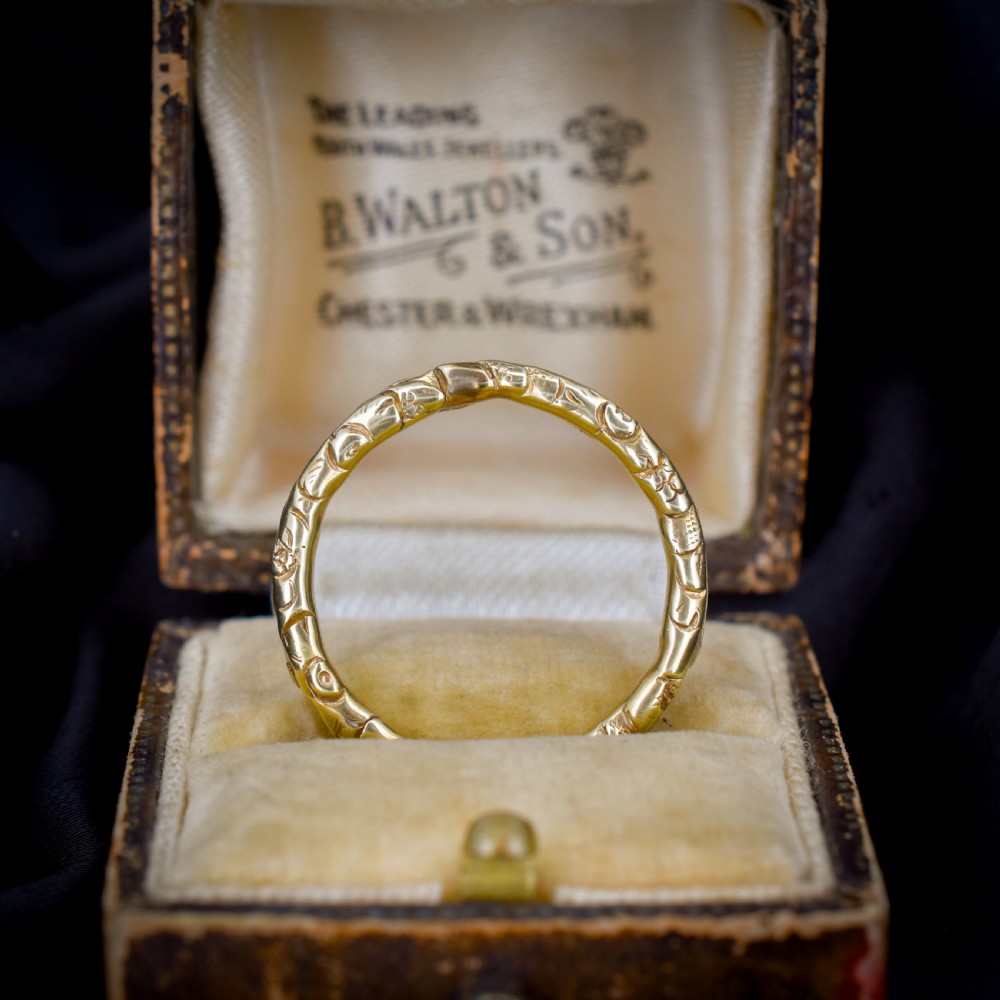 A circular Georgian 12ct yellow gold split ring featuring hand-engraved scrollwork around the outer edge. View VI