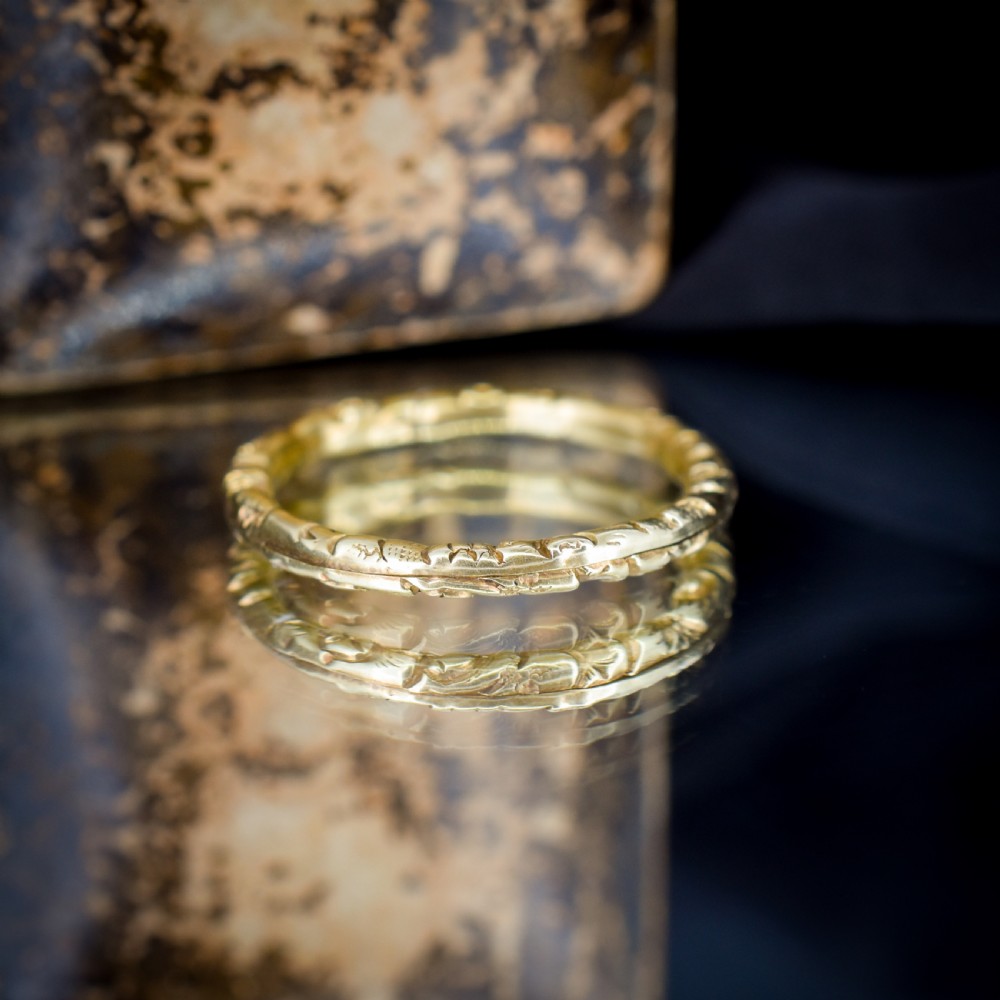 A circular Georgian 12ct yellow gold split ring featuring hand-engraved scrollwork around the outer edge. View IX