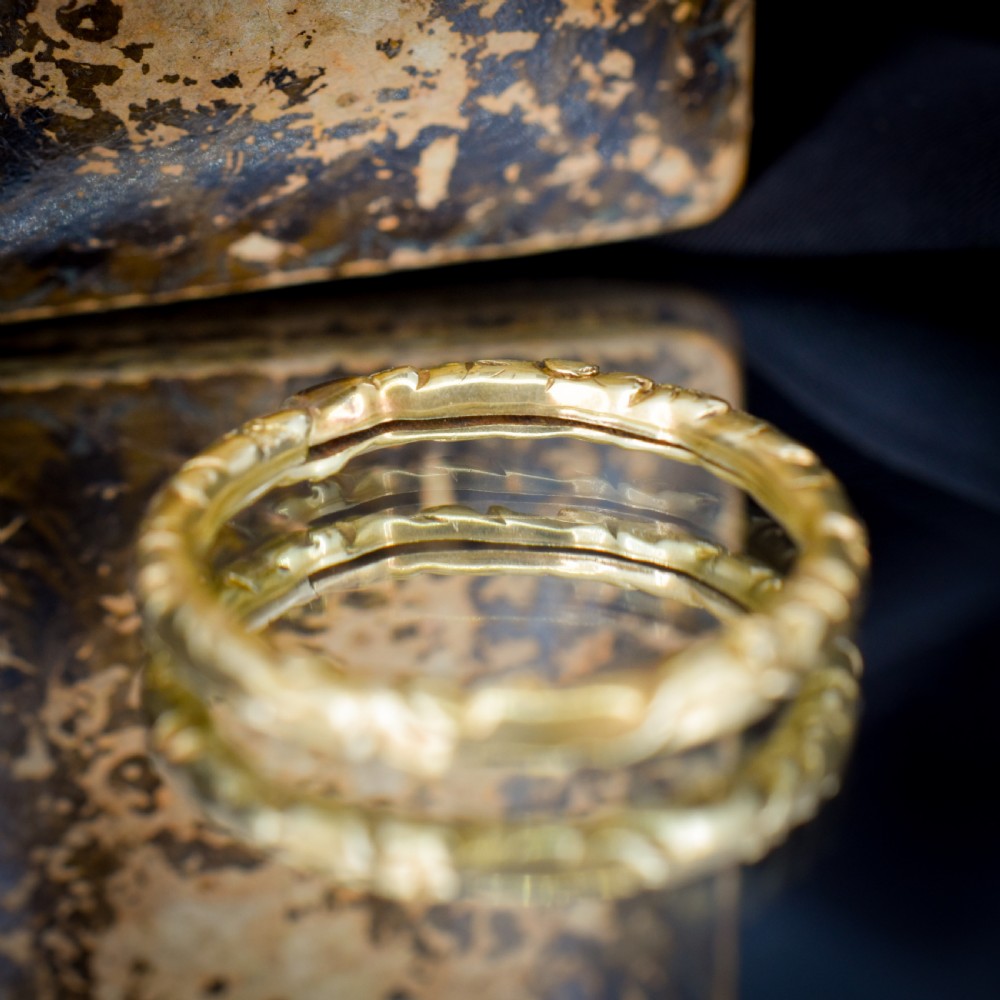 A circular Georgian 12ct yellow gold split ring featuring hand-engraved scrollwork around the outer edge. View X