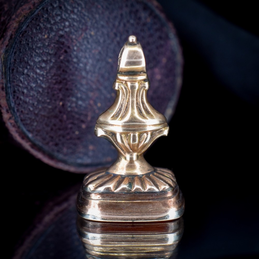 An antique gold fob pendant set with a rectangular orange carnelian gemstone carved with a classical standing figure holding a branch. View IV
