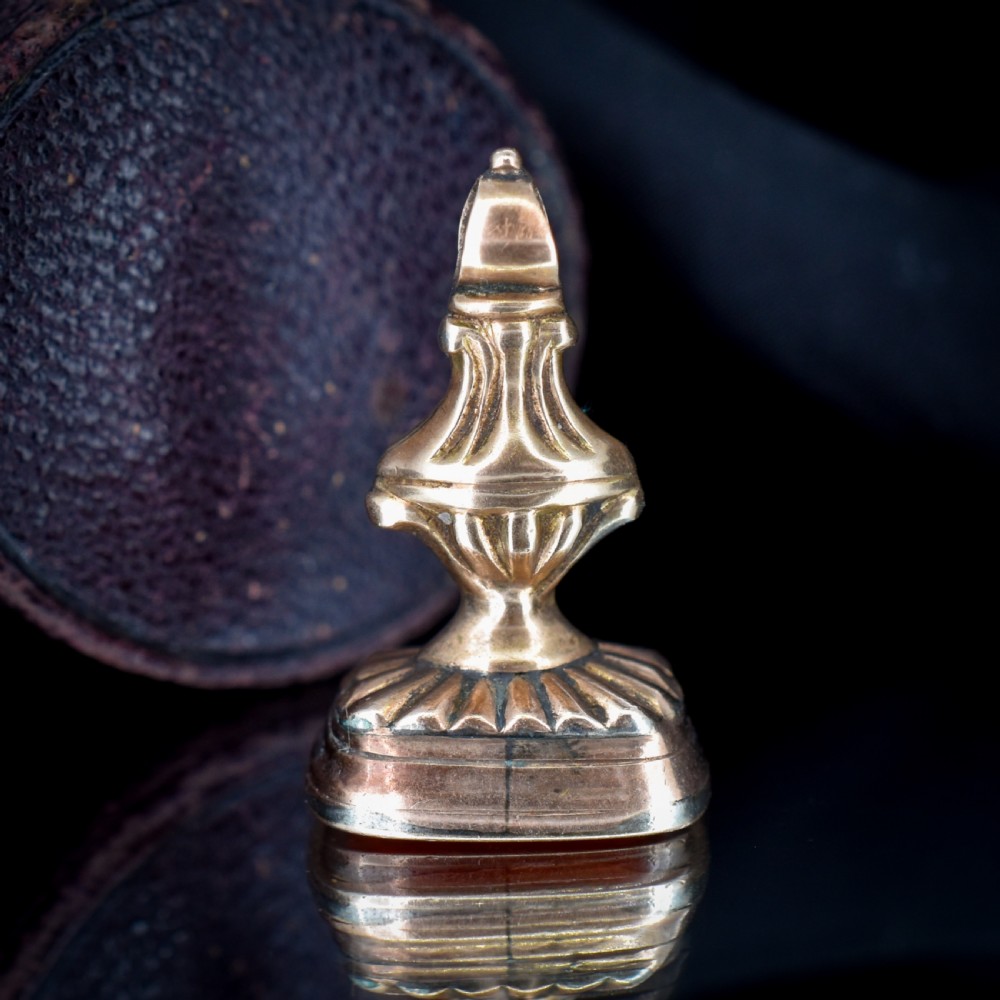 An antique gold fob pendant set with a rectangular orange carnelian gemstone carved with a classical standing figure holding a branch. View VI