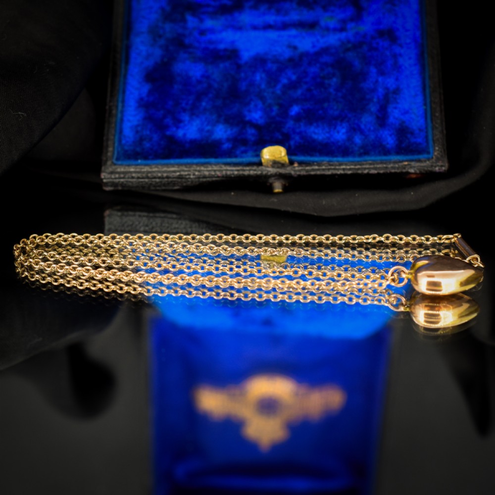 An antique 9ct yellow gold chain necklace with a smooth puffed heart pendant. View VII