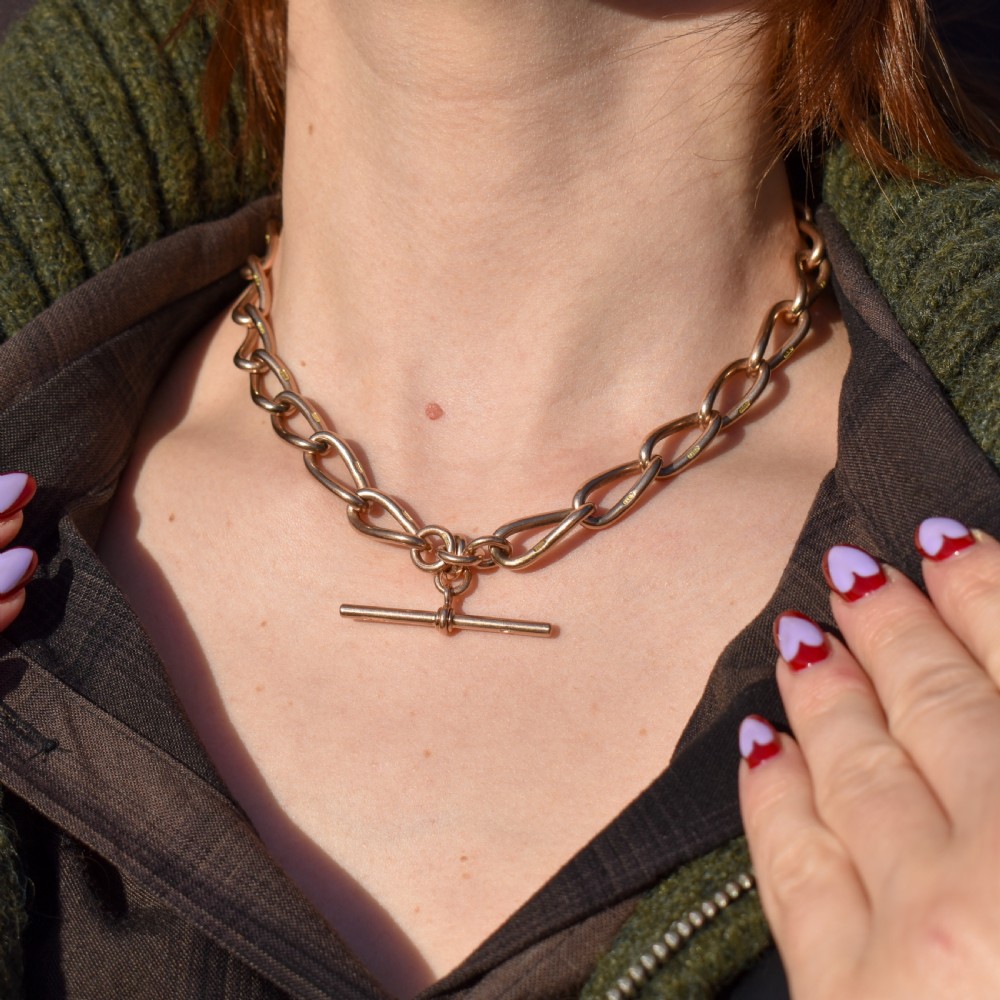 An antique 9ct yellow gold Albert watch chain necklace featuring polished oval links and a central suspended T-bar pendant. View II