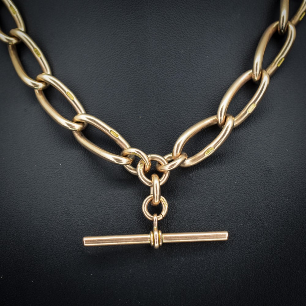 An antique 9ct yellow gold Albert watch chain necklace featuring polished oval links and a central suspended T-bar pendant. View IV