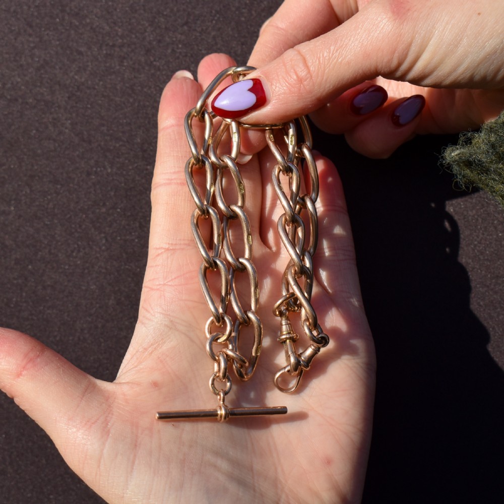 An antique 9ct yellow gold Albert watch chain necklace featuring polished oval links and a central suspended T-bar pendant. View VI