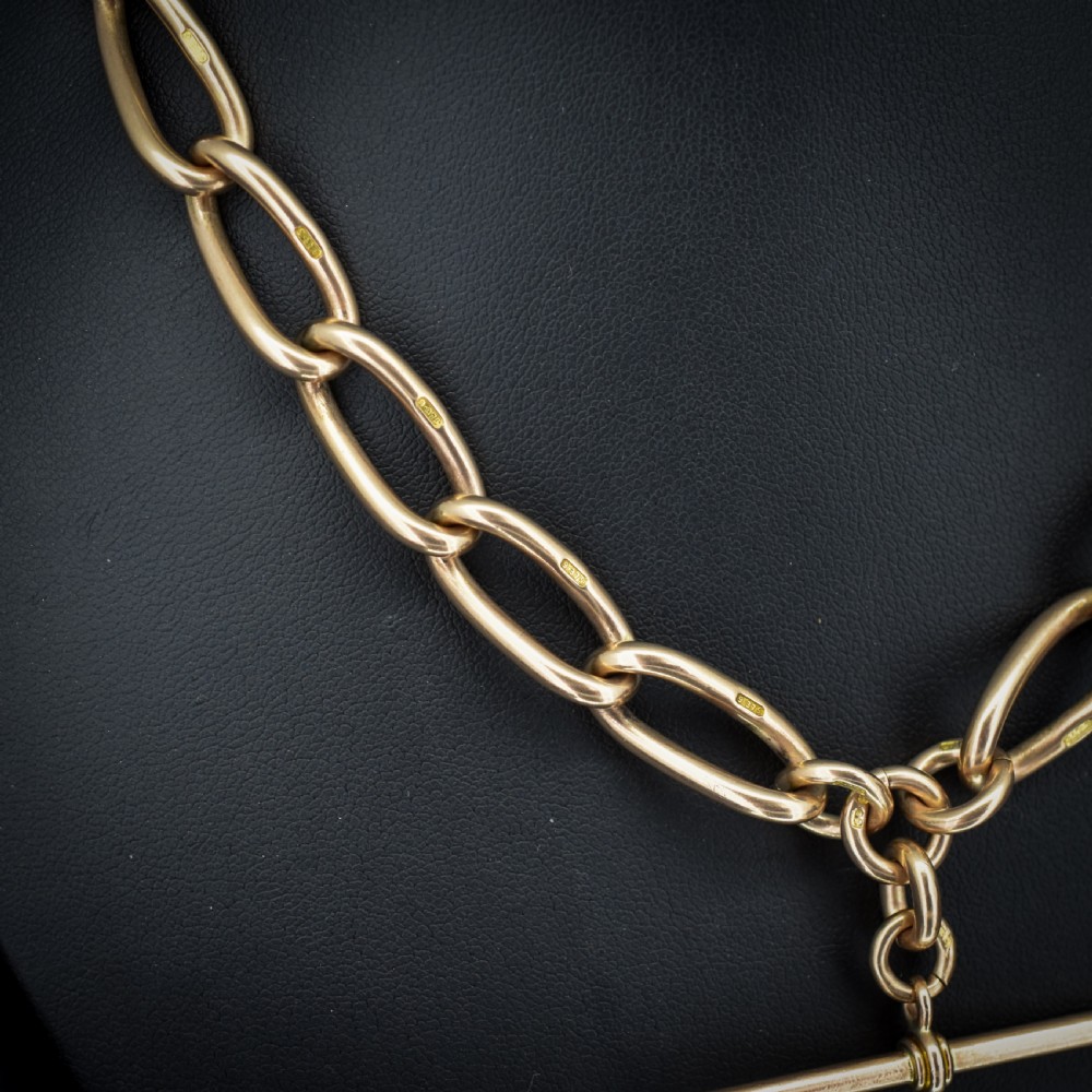 An antique 9ct yellow gold Albert watch chain necklace featuring polished oval links and a central suspended T-bar pendant. View VII