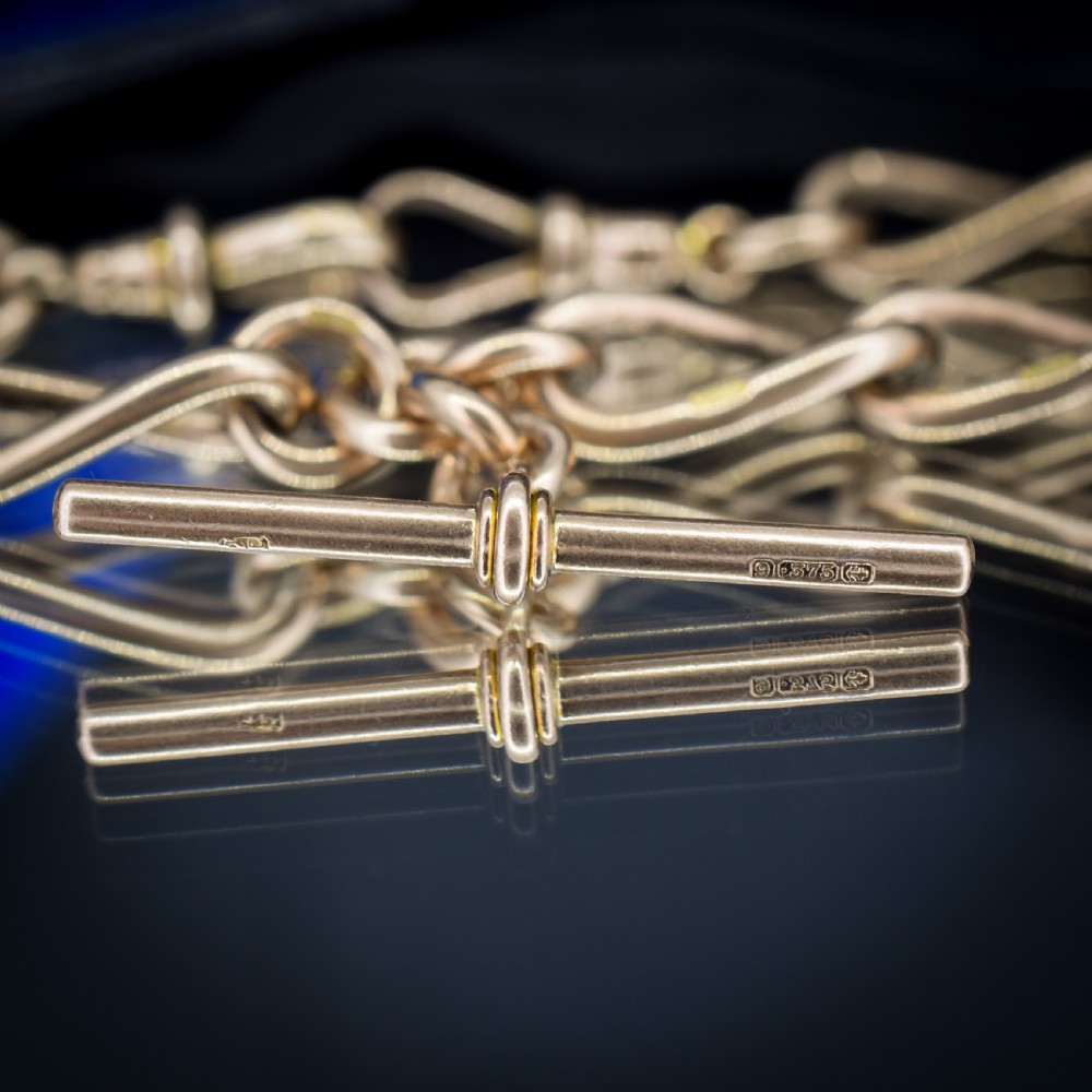 An antique 9ct yellow gold Albert watch chain necklace featuring polished oval links and a central suspended T-bar pendant. View IX