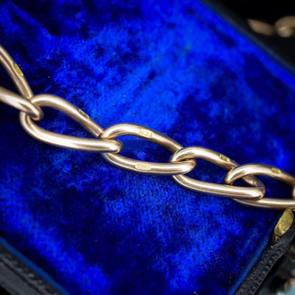 An antique 9ct yellow gold Albert watch chain necklace featuring polished oval links and a central suspended T-bar pendant. View XI