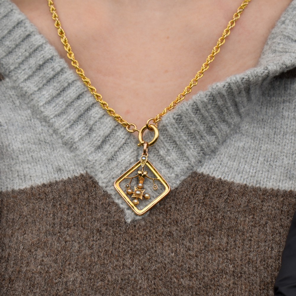 An antique 9ct yellow gold openwork lozenge-shaped pendant set with seed pearls. View III