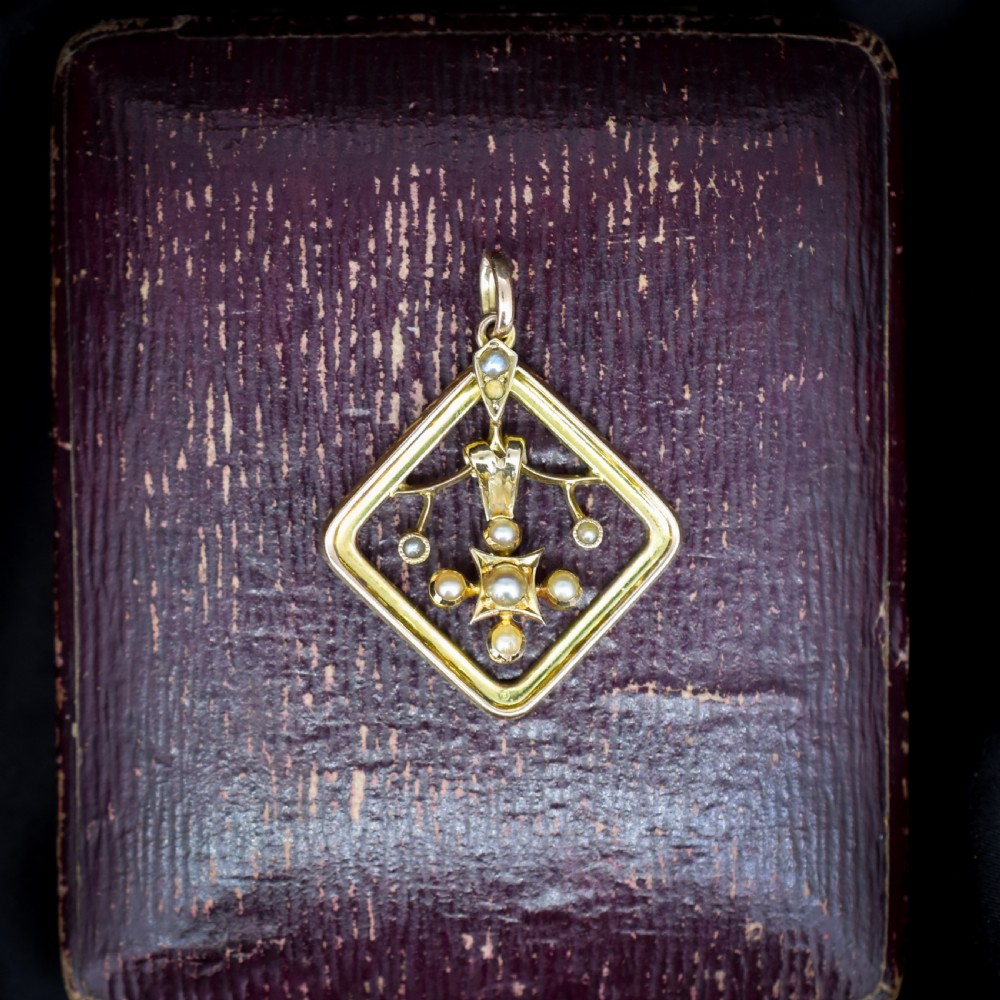 An antique 9ct yellow gold openwork lozenge-shaped pendant set with seed pearls. View VI