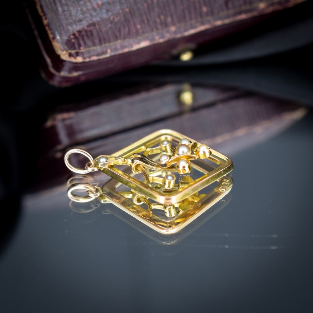 An antique 9ct yellow gold openwork lozenge-shaped pendant set with seed pearls. View VII