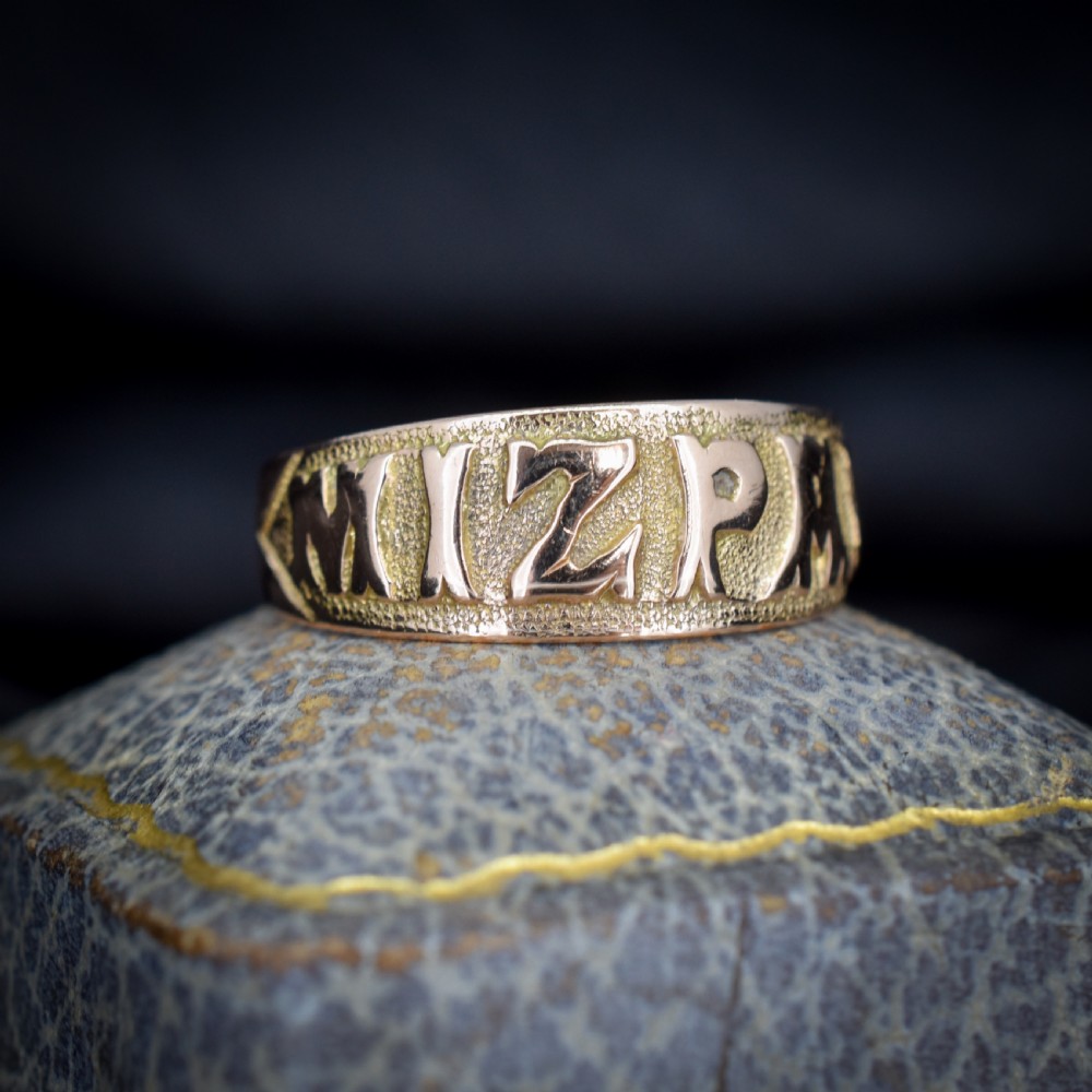 A wide 9ct gold band ring featuring the relief lettering MIZPAH set against a stippled textured background. View III