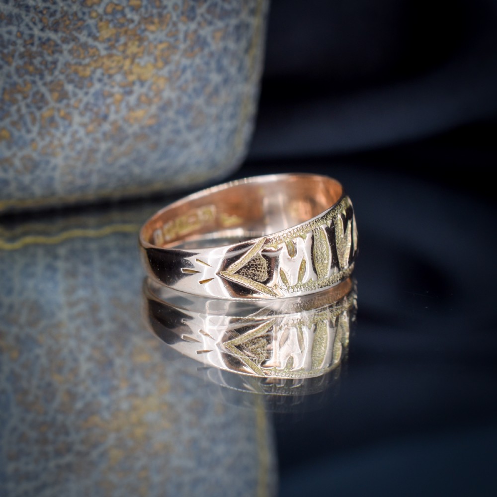 A wide 9ct gold band ring featuring the relief lettering MIZPAH set against a stippled textured background. View VII