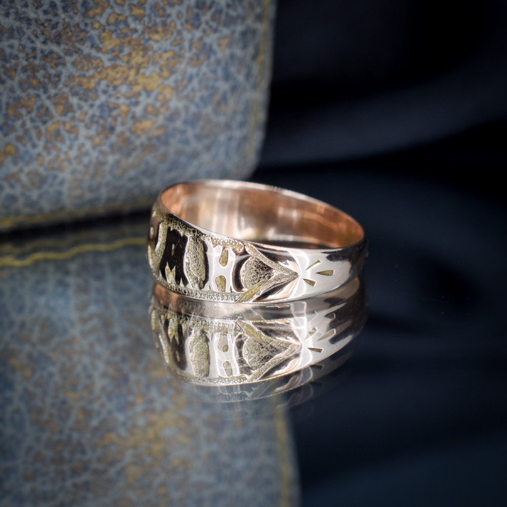 A wide 9ct gold band ring featuring the relief lettering MIZPAH set against a stippled textured background. View VIII