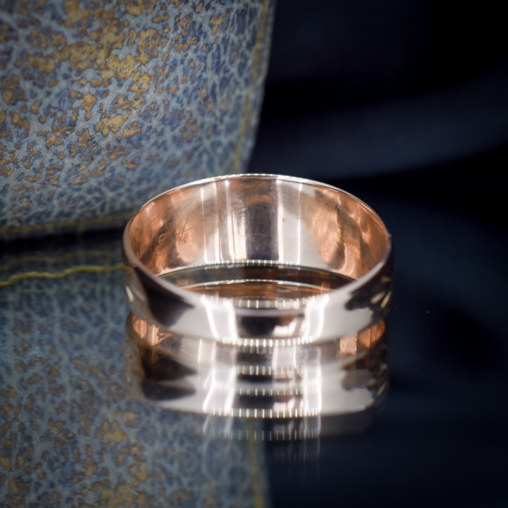 A wide 9ct gold band ring featuring the relief lettering MIZPAH set against a stippled textured background. View IX