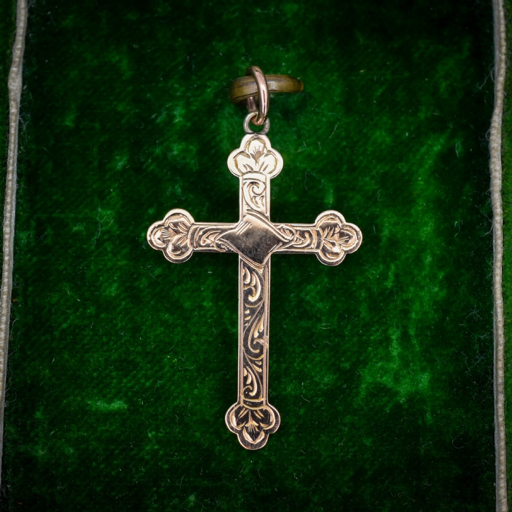 An Edwardian 9ct yellow gold cross pendant featuring hand-engraved foliate scrollwork, trefoil ends, and a circular top jump ring. View III
