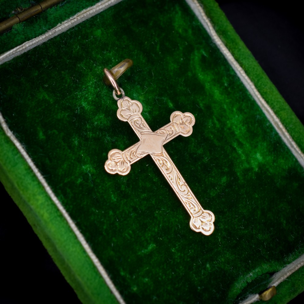 An Edwardian 9ct yellow gold cross pendant featuring hand-engraved foliate scrollwork, trefoil ends, and a circular top jump ring. View VII