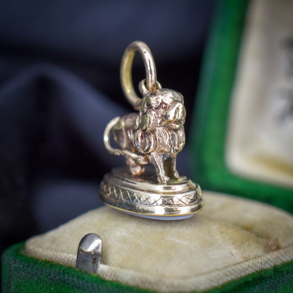 An antique gold fob seal featuring a three-dimensional standing lion figure on an engraved oval base set with a sardonyx stone. View VI