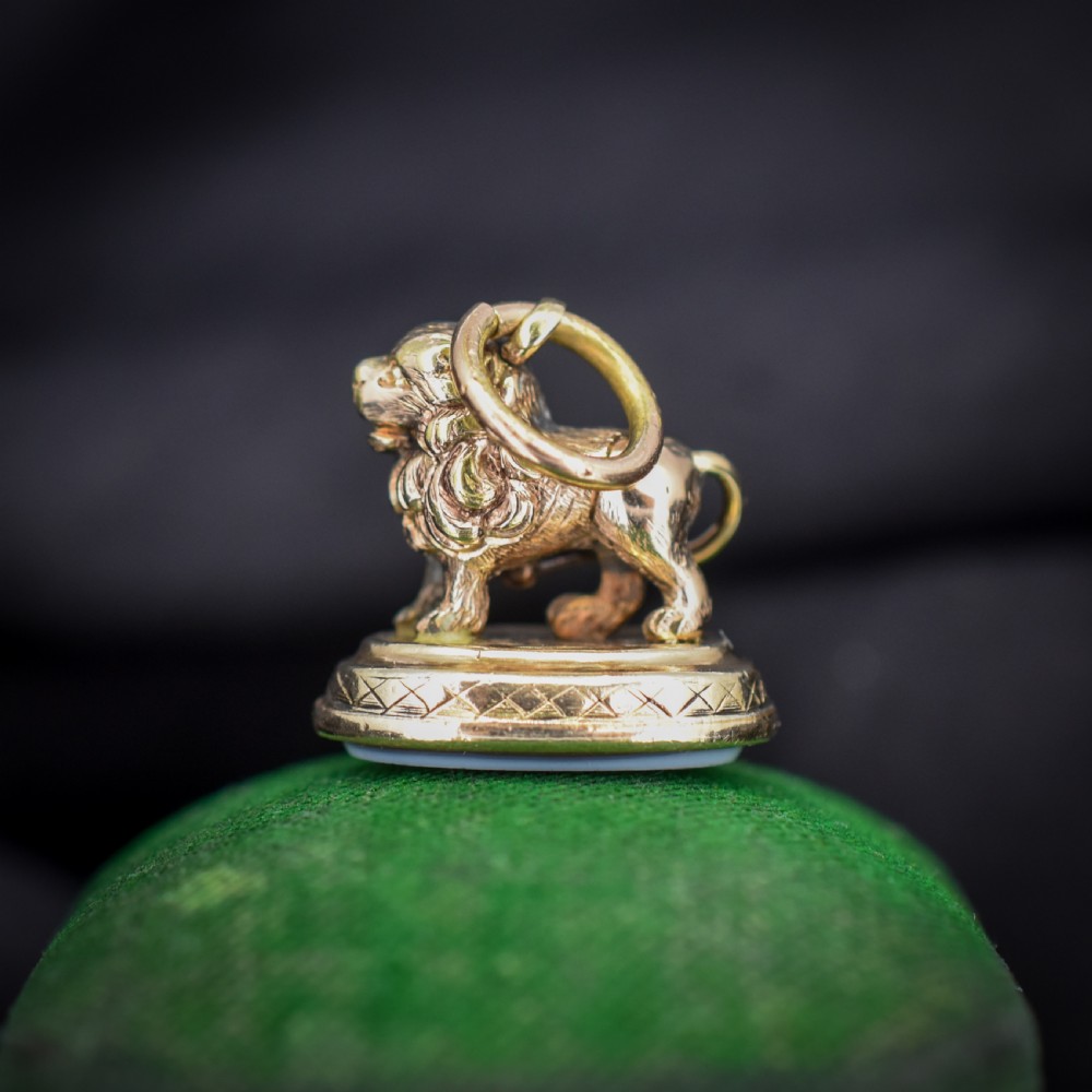 An antique gold fob seal featuring a three-dimensional standing lion figure on an engraved oval base set with a sardonyx stone. View VII
