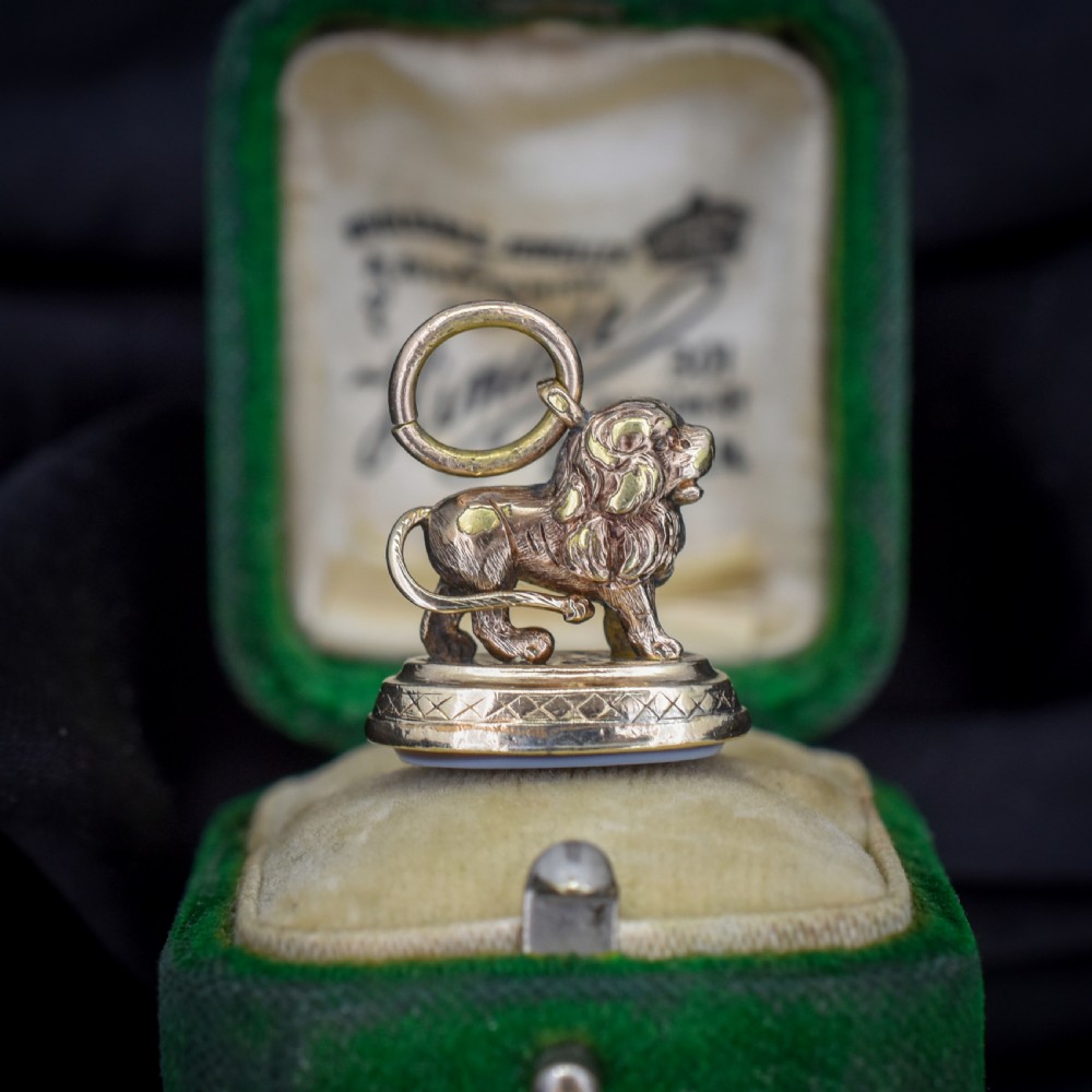 An antique gold fob seal featuring a three-dimensional standing lion figure on an engraved oval base set with a sardonyx stone. View VIII
