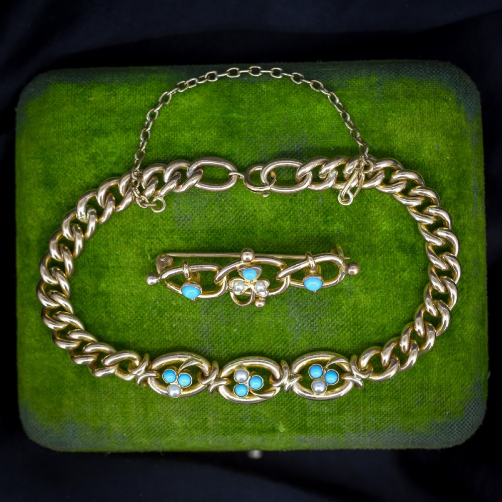 An antique rolled gold jewellery set featuring a curb link bracelet with turquoise and pearl embellishments alongside a matching bar brooch.