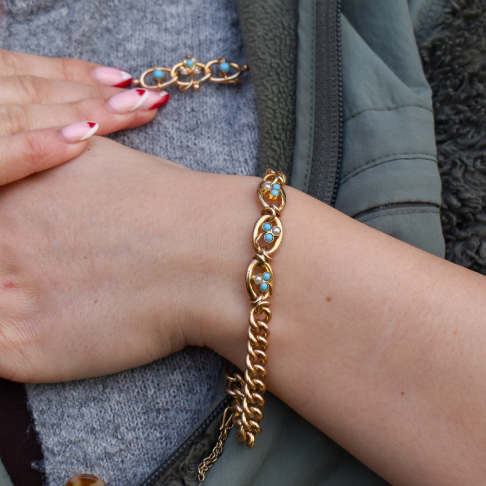 An antique rolled gold jewellery set featuring a curb link bracelet with turquoise and pearl embellishments alongside a matching bar brooch. View IV