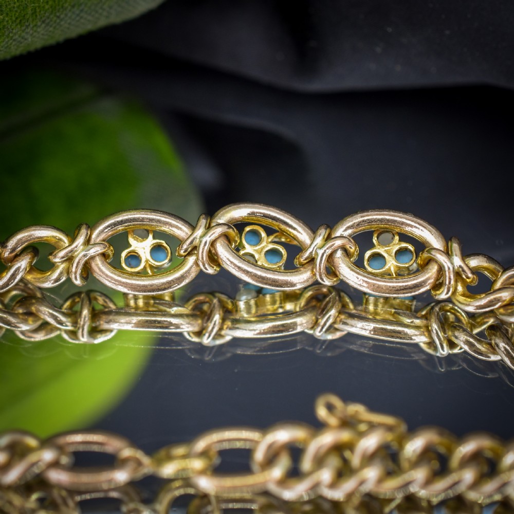 An antique rolled gold jewellery set featuring a curb link bracelet with turquoise and pearl embellishments alongside a matching bar brooch. View VII