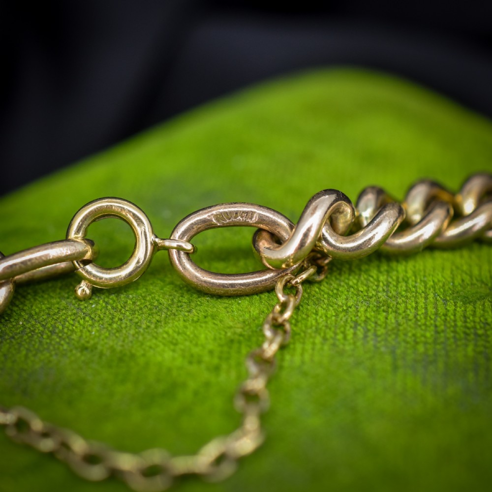 An antique rolled gold jewellery set featuring a curb link bracelet with turquoise and pearl embellishments alongside a matching bar brooch. View VIII