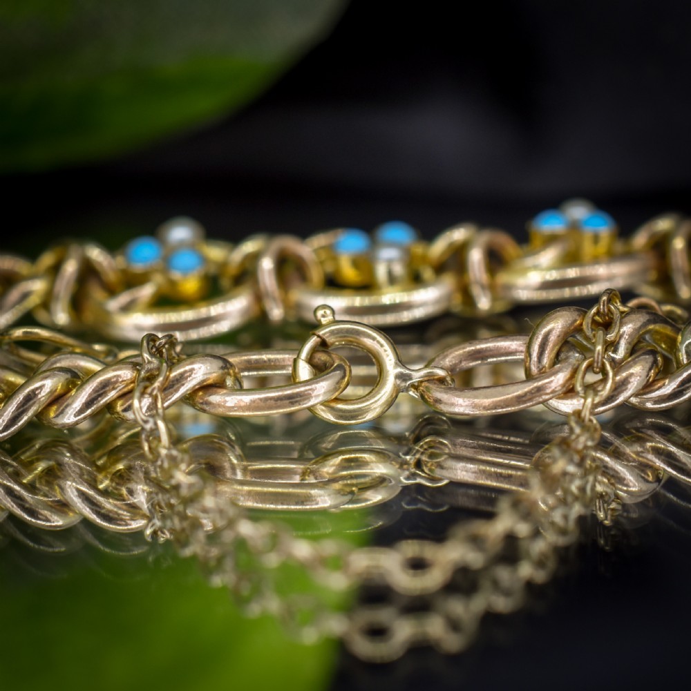 An antique rolled gold jewellery set featuring a curb link bracelet with turquoise and pearl embellishments alongside a matching bar brooch. View IX