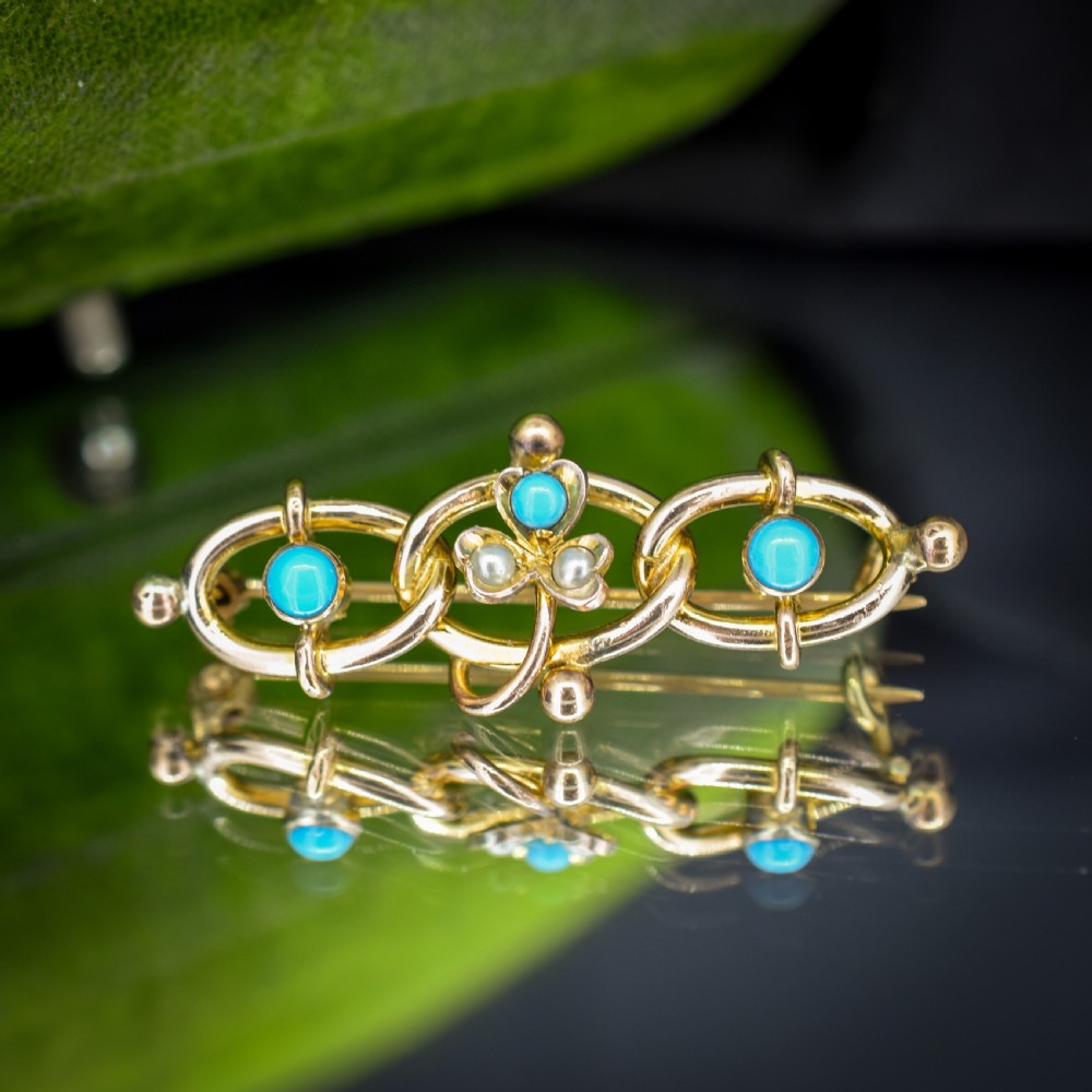An antique rolled gold jewellery set featuring a curb link bracelet with turquoise and pearl embellishments alongside a matching bar brooch. View X
