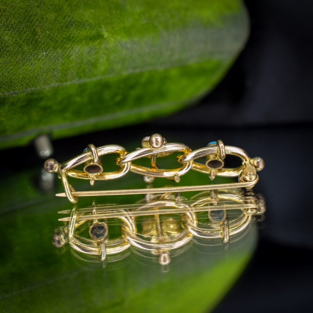 An antique rolled gold jewellery set featuring a curb link bracelet with turquoise and pearl embellishments alongside a matching bar brooch. View XI