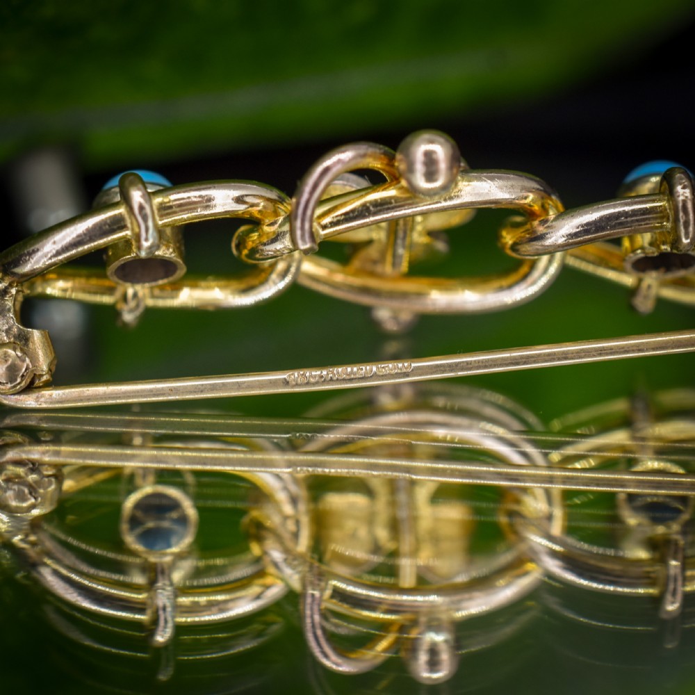 An antique rolled gold jewellery set featuring a curb link bracelet with turquoise and pearl embellishments alongside a matching bar brooch. View XII