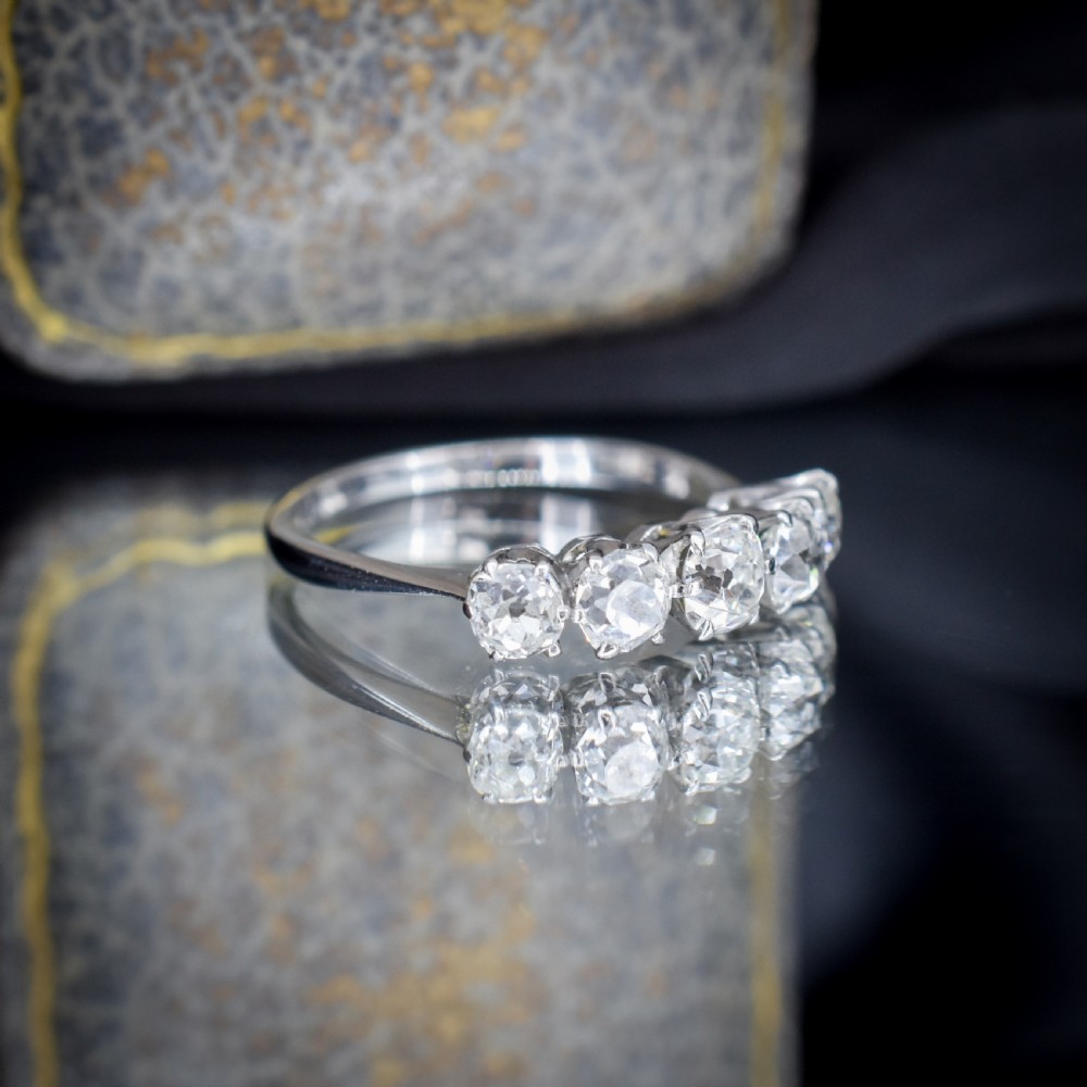An 18ct white gold five-stone ring set with five graduated old-cut diamonds in claw settings. View VIII